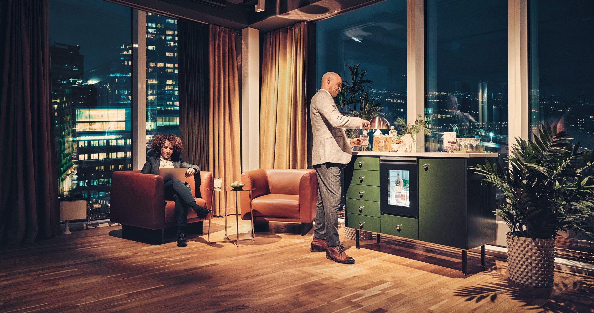 Man and woman in a hotel room, using the Dometic HiPro Minibar