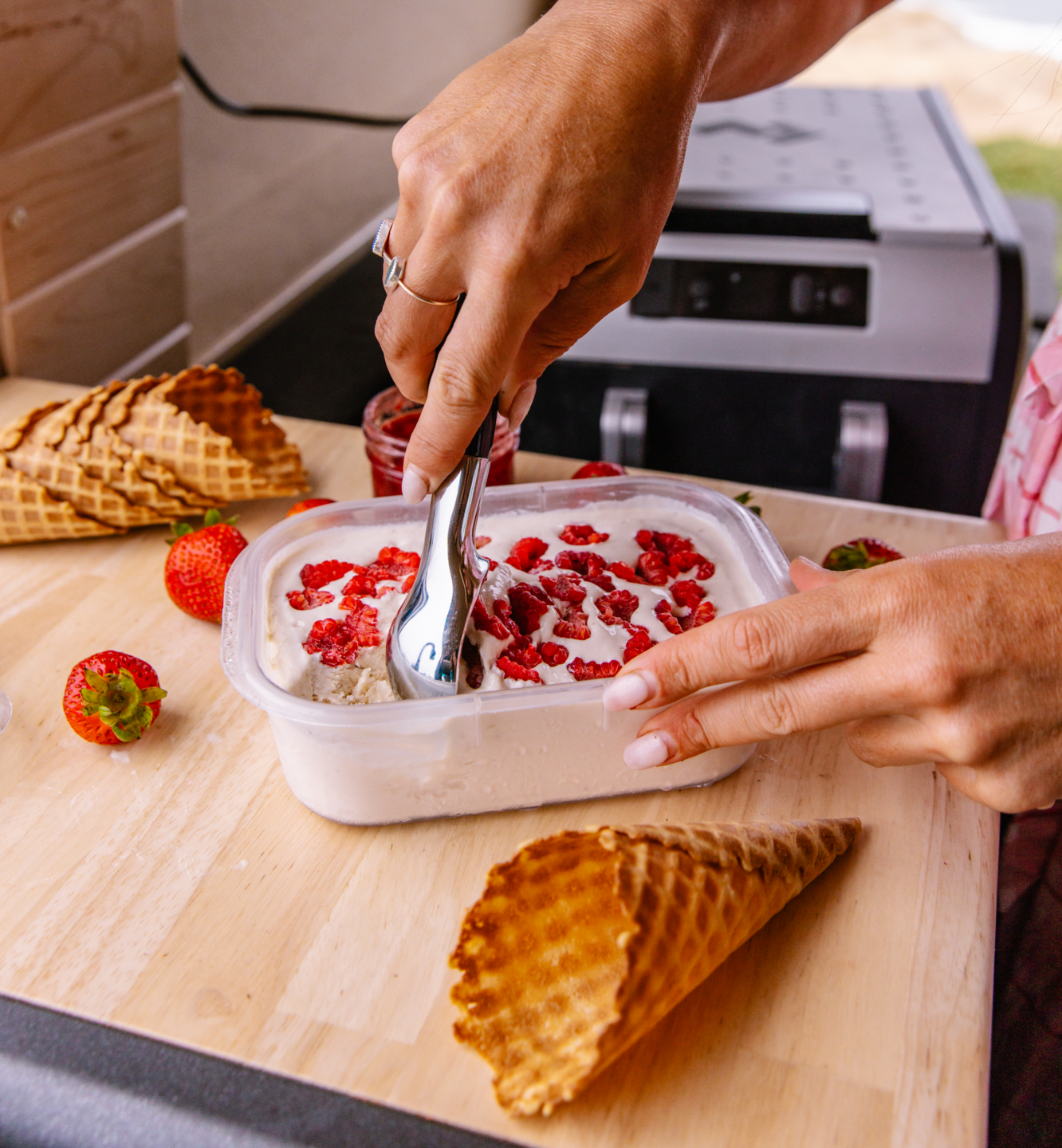 Sarah Glover scooping ice cream made from Dometic electric cooler