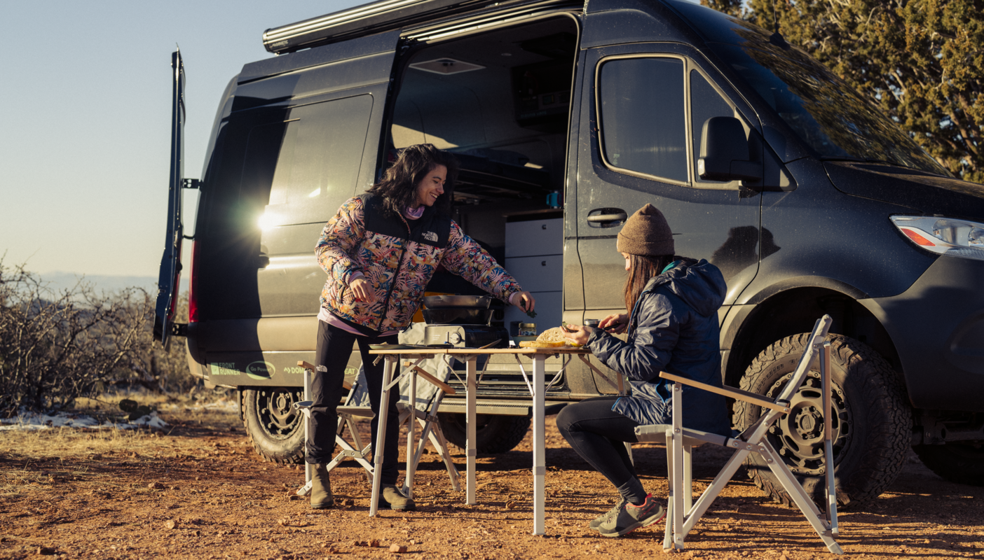 Nina William's and friend eating outside of van