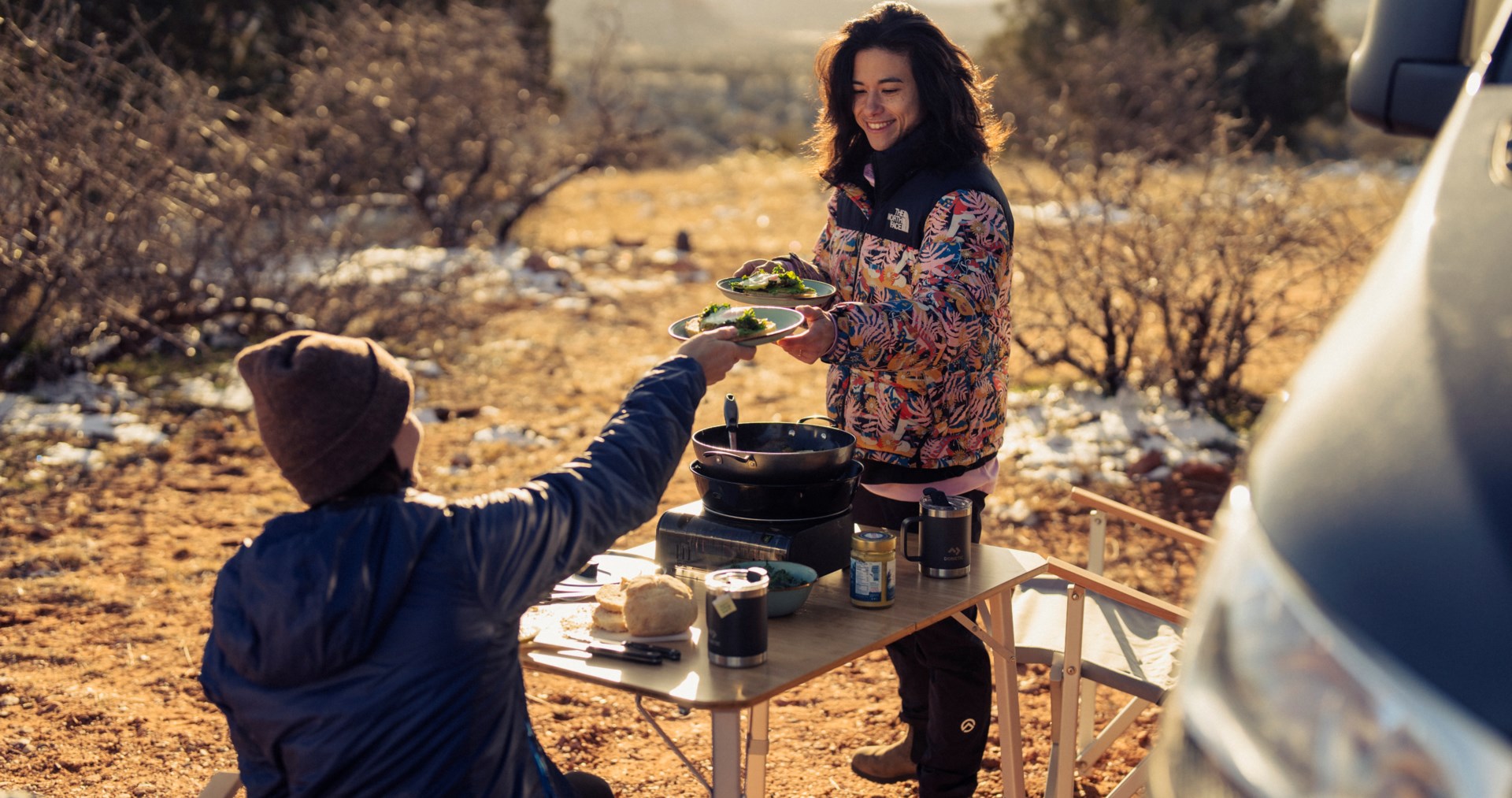 Nina Williams outside cooking with friend