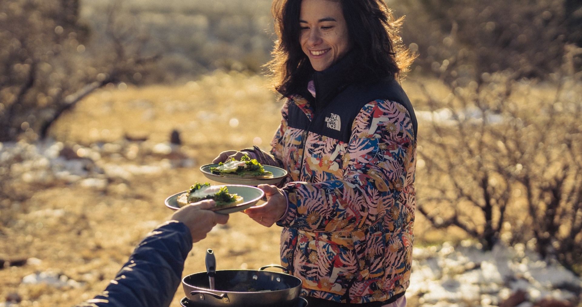 Nina Williams outside cooking with friend