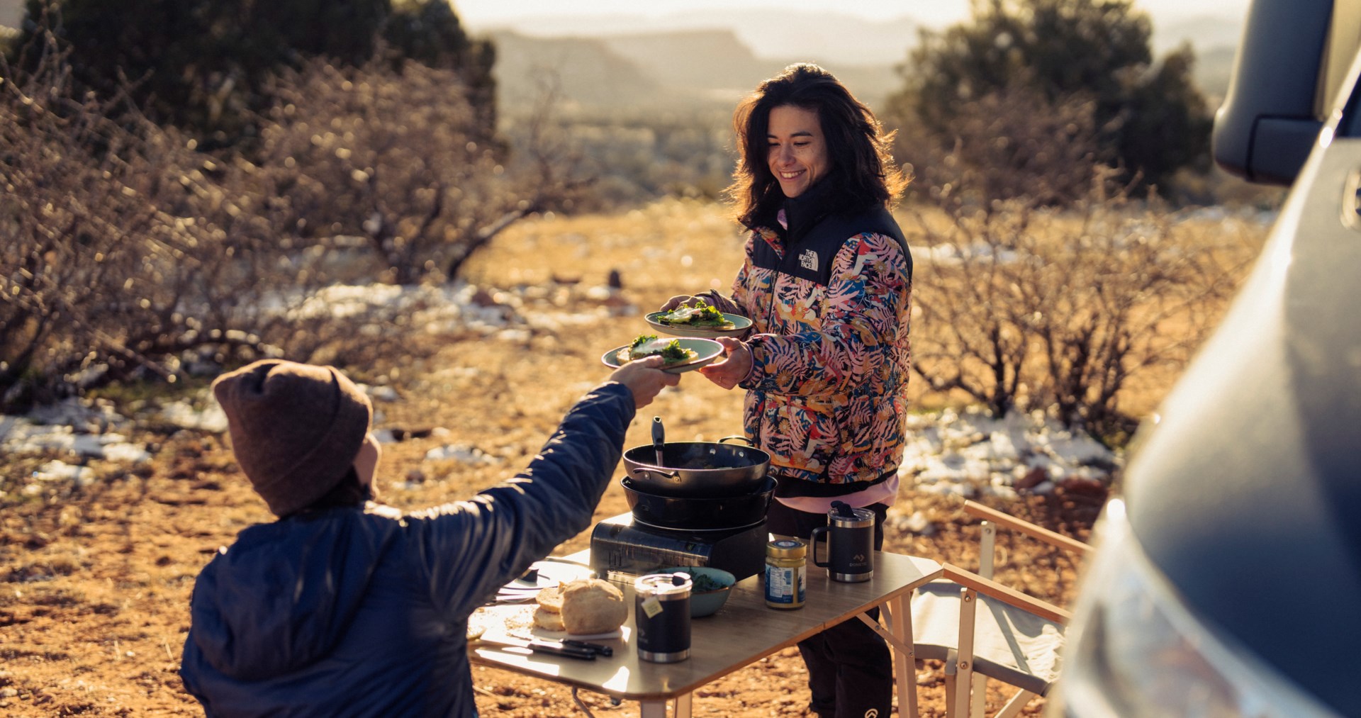 Nina Williams outside cooking with friend
