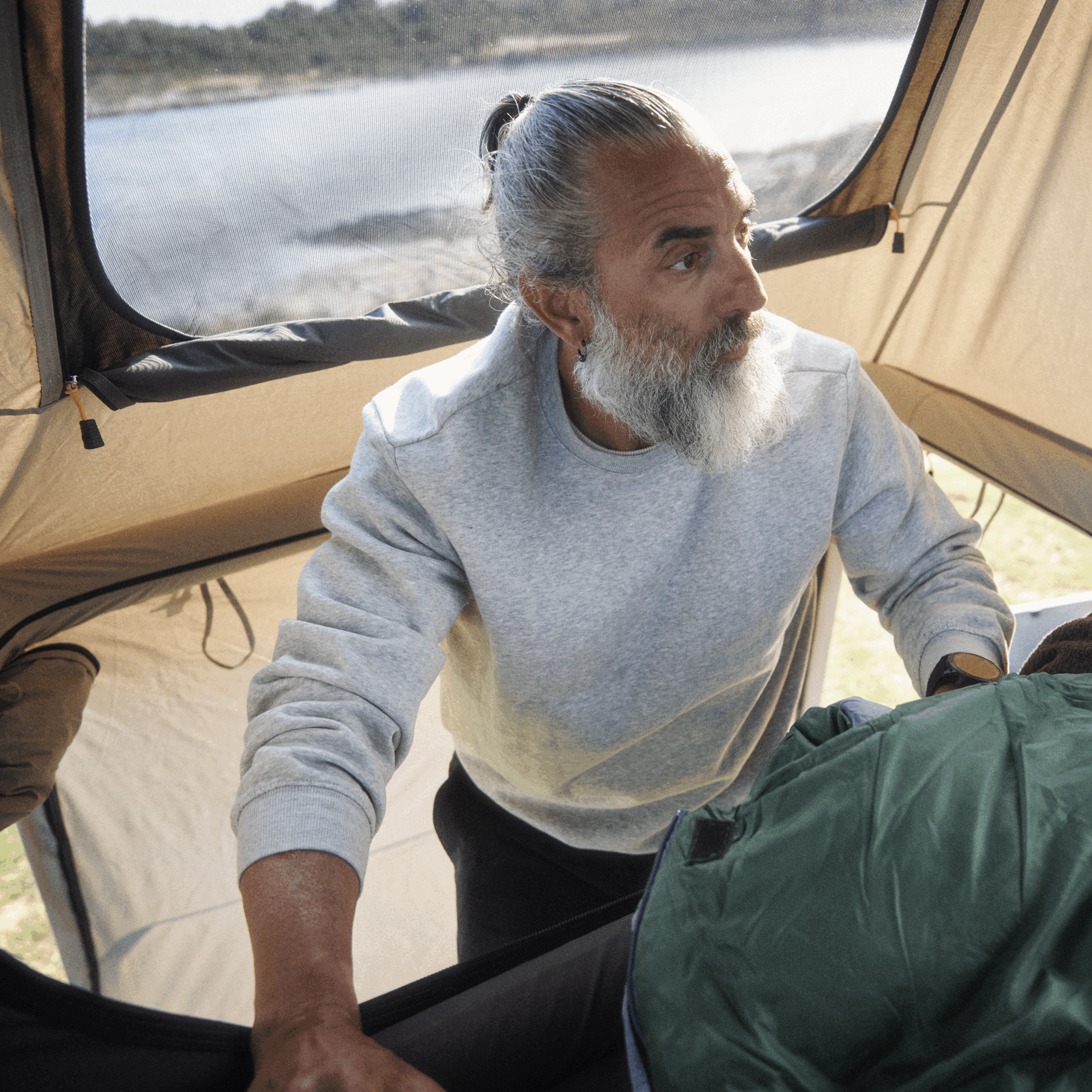 Man climbing into a rooftop tent