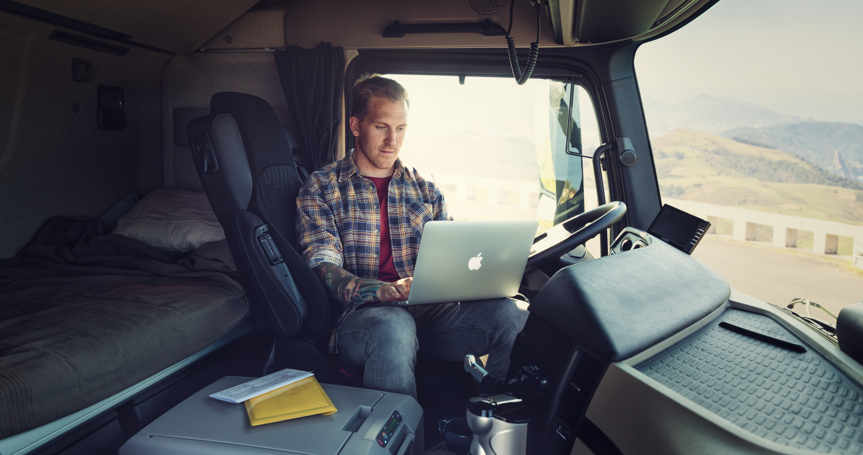 Man sitting in truck on his laptop