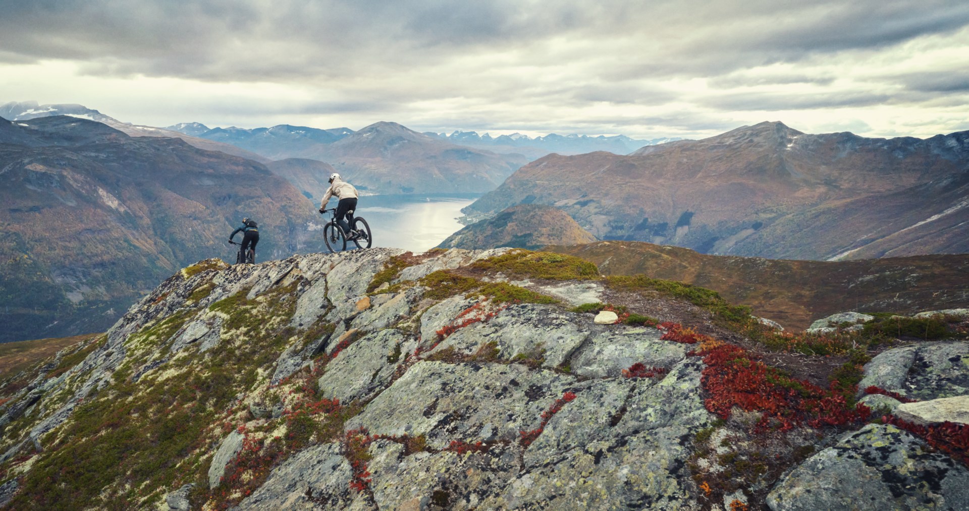 2 people mountain biking on top of a rocky mountain