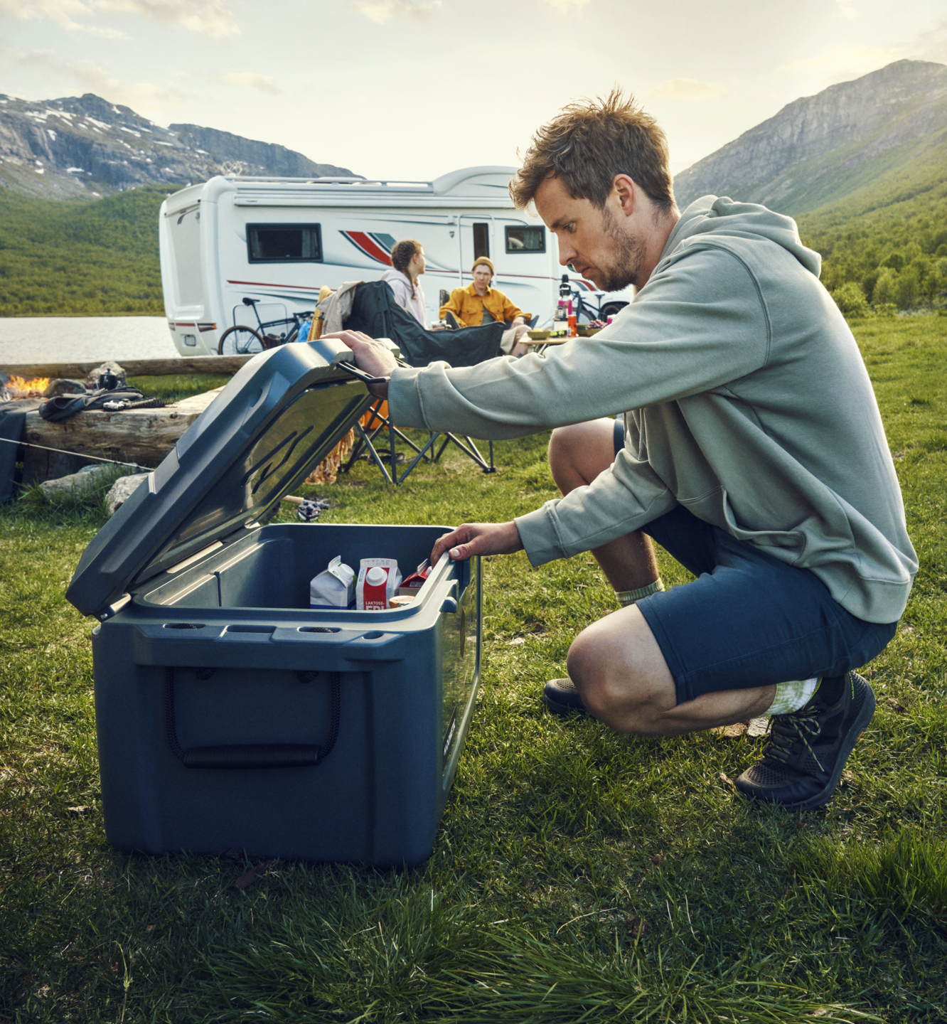 man grabbing item from ice chest