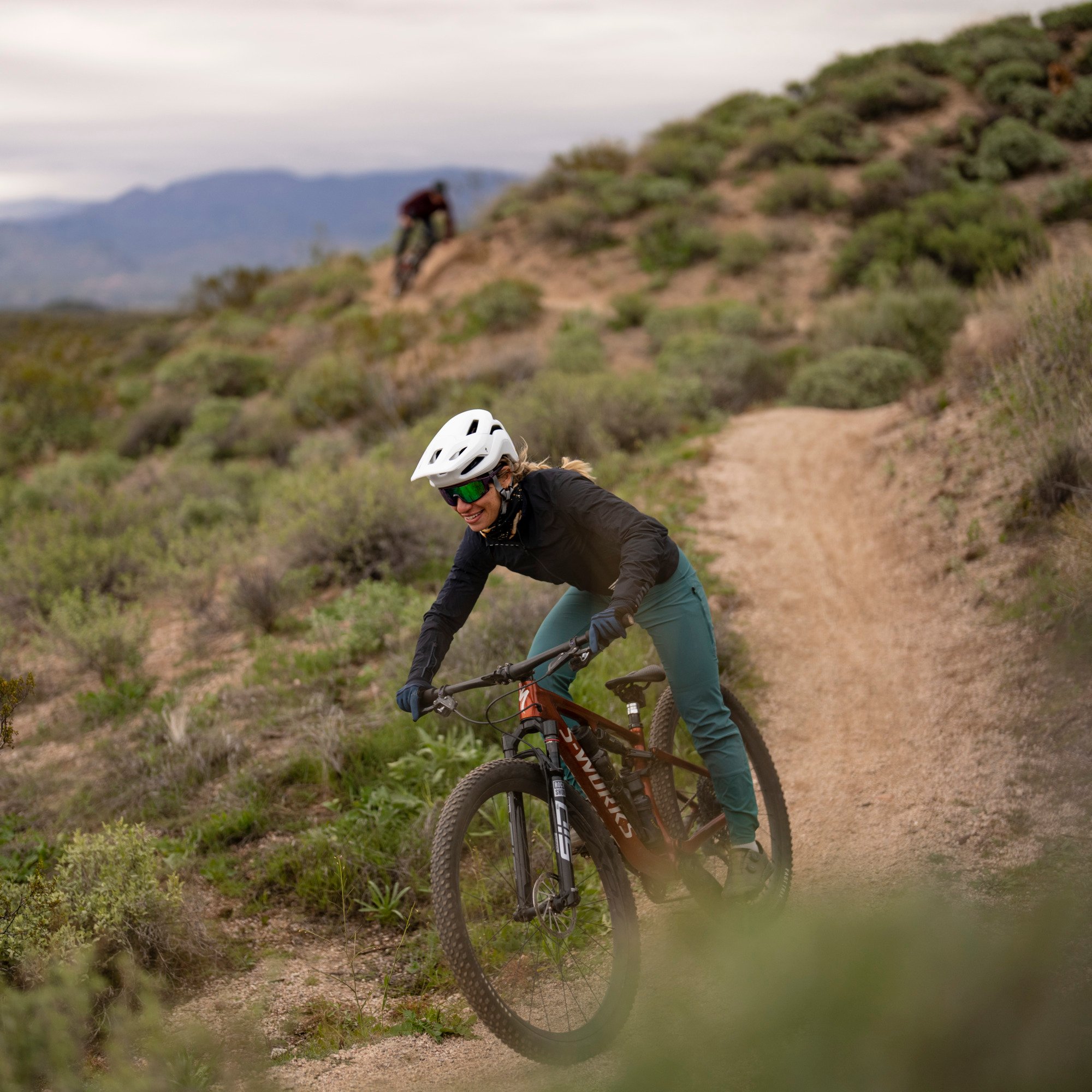 Women mountain biking on trail