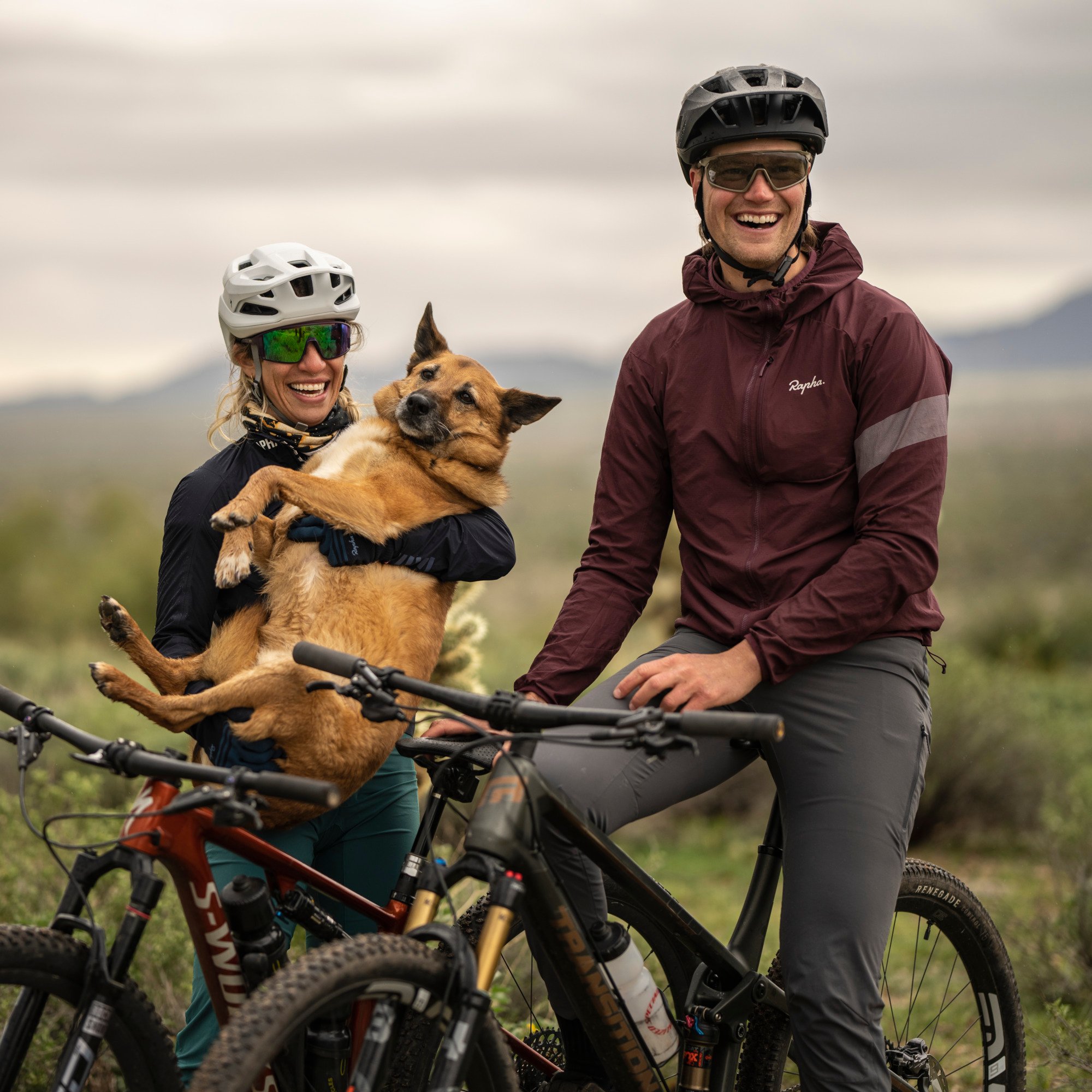couple with a dog on a mountain biking trail